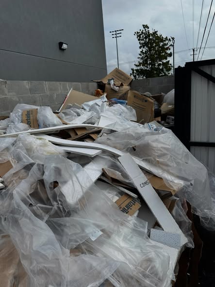 Pile of construction debris, drywall and packaging waste before removal