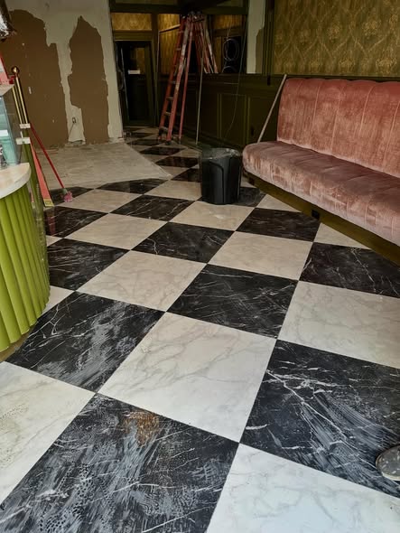 Interior space with checkered tile floor fully cleaned out and ready for the next phase